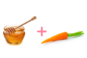 Orange blend of fresh carrot and golden honey in a small ceramic bowl