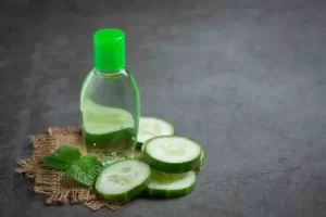 Sliced cucumber and a soothing DIY face spray in a frosted bottle