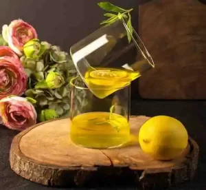 Sliced lemons and a yellow-hued toner mix in a small glass bottle
