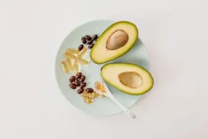 ipe avocado blended with vitamin E oil dripping from capsule for dewy glow.