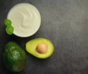 DIY avocado face mask with yogurt shown in glass jar for deep moisture.