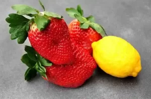 Fresh lemon and strawberry mix in a bowl for oily skin treatment.