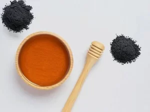 Raw honey mixed with charcoal powder for soft, hydrated skin.