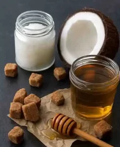 Brown sugar, coconut oil and honey lip scrub on spoon.