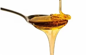 Honey in a small bowl used as a lip scrub.