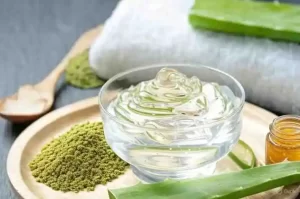 Green matcha powder blended with aloe vera and honey for skincare.