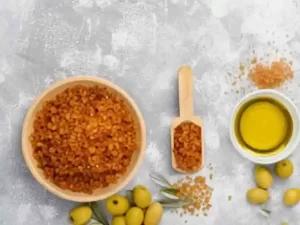 Olive oil and sugar lip scrub in a glass bowl.