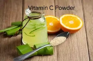 Aloe vera gel and vitamin C powder mixed in a small skincare dish.
