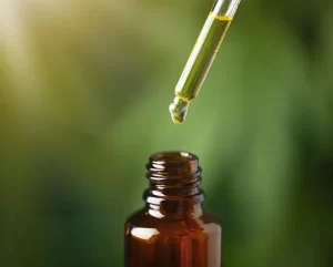 Tea tree oil bottle with dropper used for acne scars.