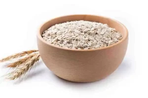 Ground oatmeal in a wooden bowl for scalp remedy.