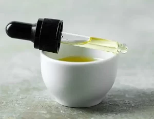 Olive oil in a bottle with fresh olives.